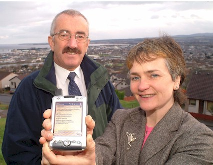 Pauline chapman, Librarian Database Co-ordinator demonstrates to Councillor Andrew Anderson, Chairman of The Highland Council's Education, Culture and Sport Committee how the Talis Prism Highland Libraries Catalogue can be accessed any time, any place, anywhere.