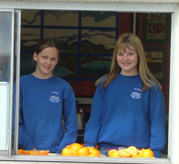 Photo:  Two Hillhead pupils get ready to serve up the oranges