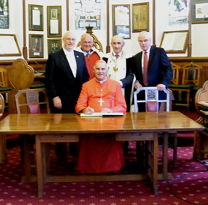 Photo: Cardinal O'Brien Signs the Visitor Book At The Town House, Inverness