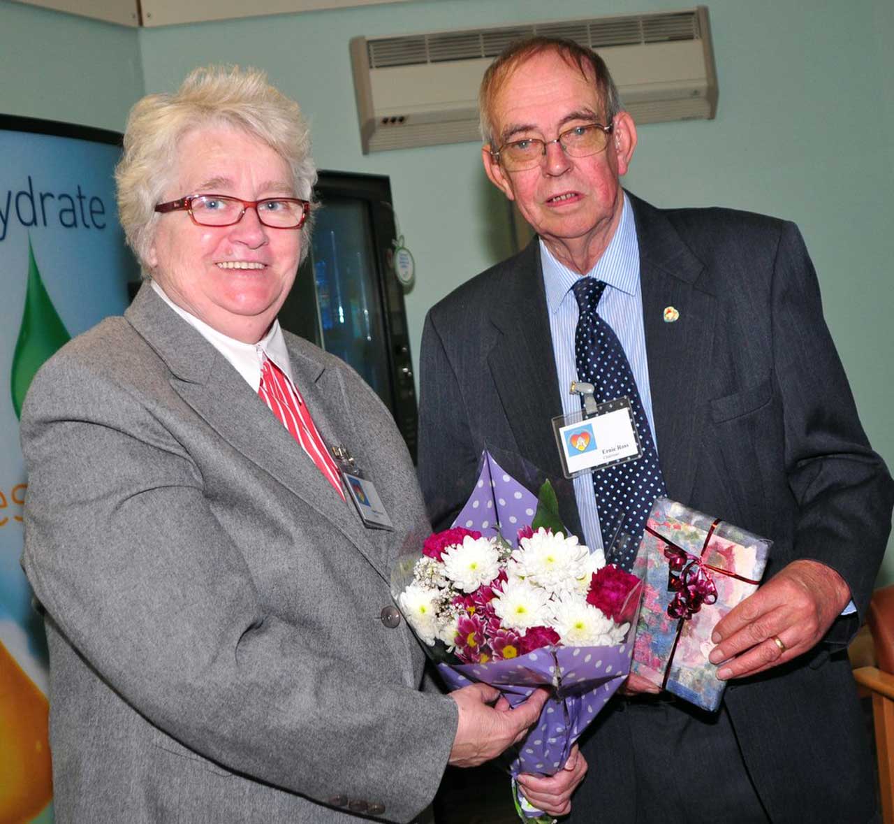 Photo: Flowers and a gift for Miss Dunnet, presented by group chairman Ernie Ross