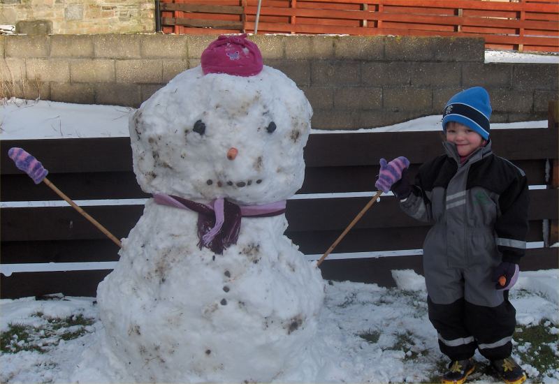 Photo: Winter Finally Comes To Caithness - Bryony Munro and Her Snowman 2 March 2006