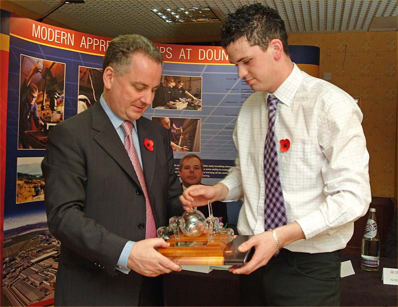 Photo: Gary Davidson presenting Jack McConnell with a glass model of DFR