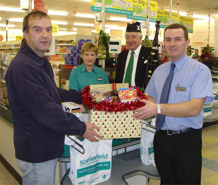 Photo: First Customer Charles Ferguson Receives Free Box Of Groceries From Manager Brian Wares